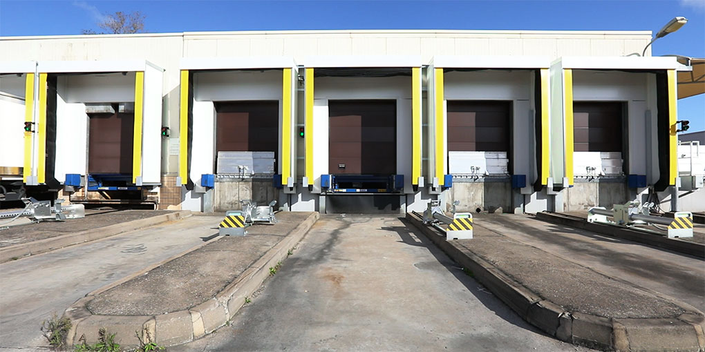 Wheel‑restraint systems on a food‑processing shipping bay